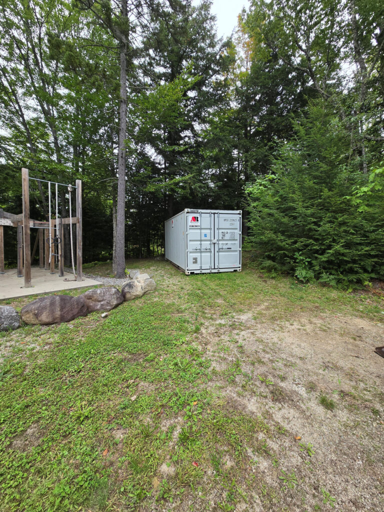 A 20ft storage container was delivered to Greenwood, ME to help store basement items after pipes burst and cleanup began.