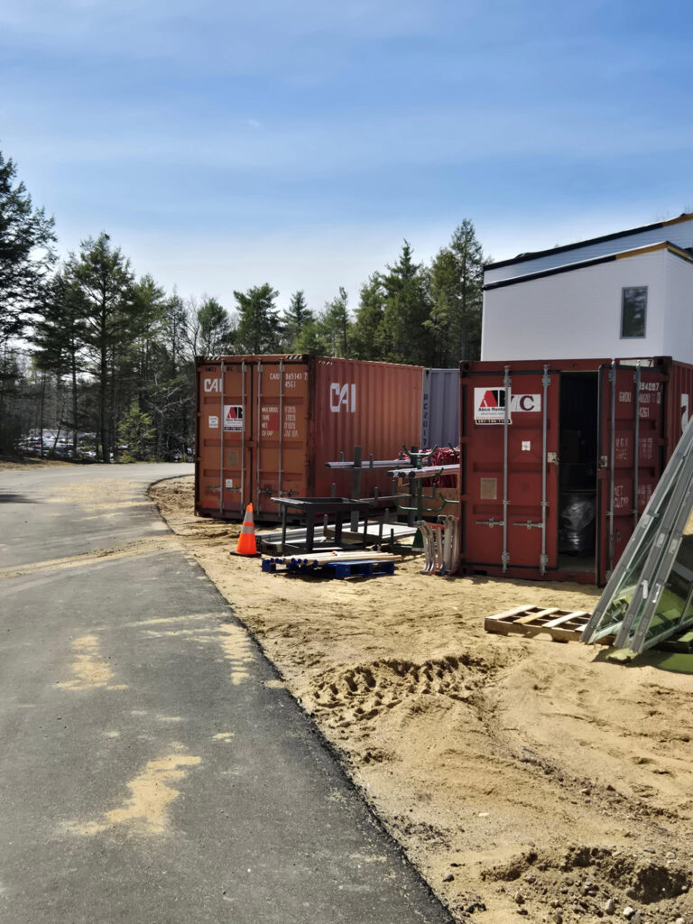 Job site storage container for renovation project in Alfred Maine with 40-foot high cube Conex container for contractor use.