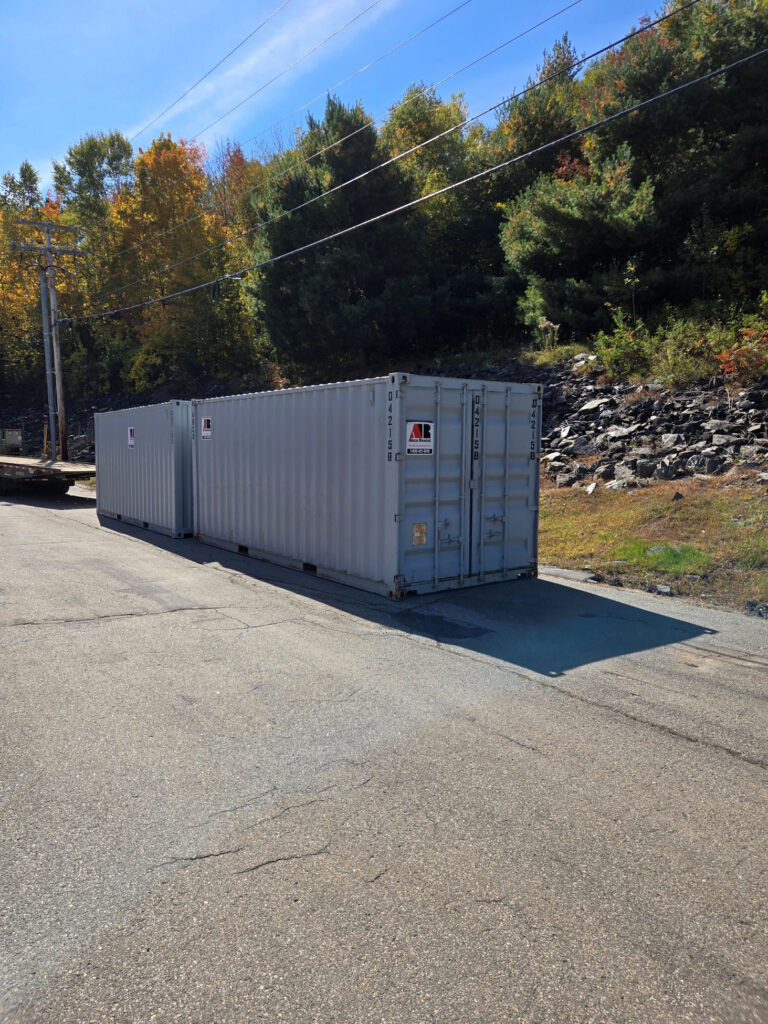 Two 20ft Abco Rental and Storage shipping containers delivered to a grocery store construction site in Farmington Maine.