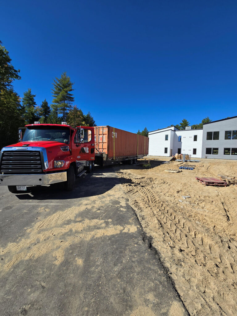 Exterior angle of a weatherproof 40ft shipping container showcasing high-security double cargo swing doors on a commercial site.