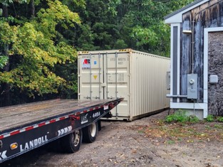 40’ high cube container rental for household goods and furniture in Windham, ME 04062. Our customer requested to have the mobile storage container rental dropped beside their detached garage, tight to the tree line.