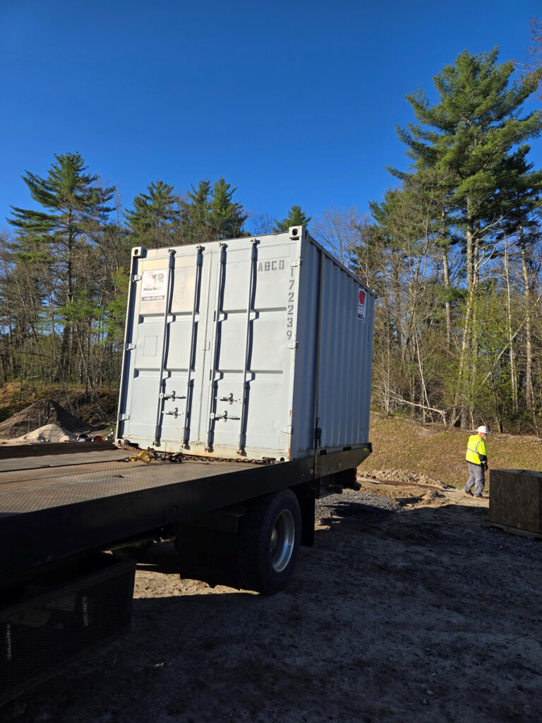 10ft storage container pickup from a WWTP project in Windham, Maine for ES Boulos electrical contractor. Reliable job site storage rentals in Maine.